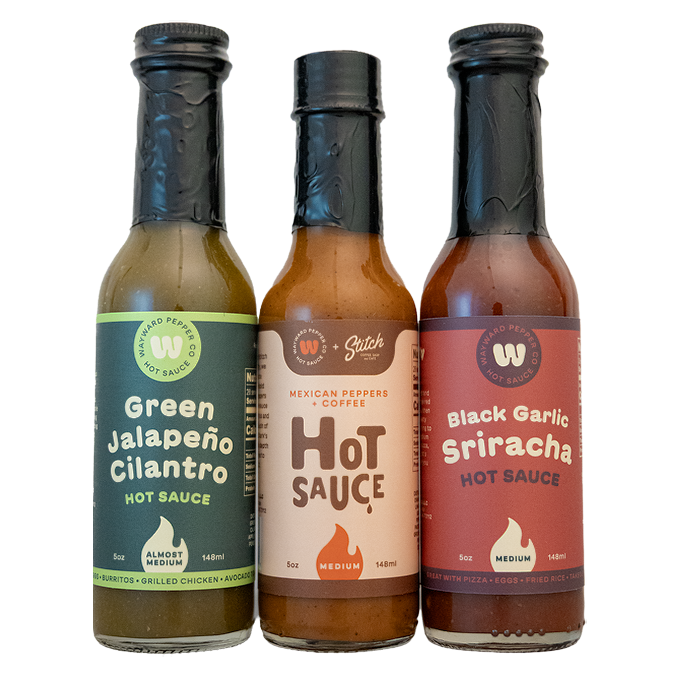 Trust Me Bundle: Green Jalapeño Cilantro, Mexican Peppers & Coffee, and Black Garlic Sriracha hot sauce bottles side by side